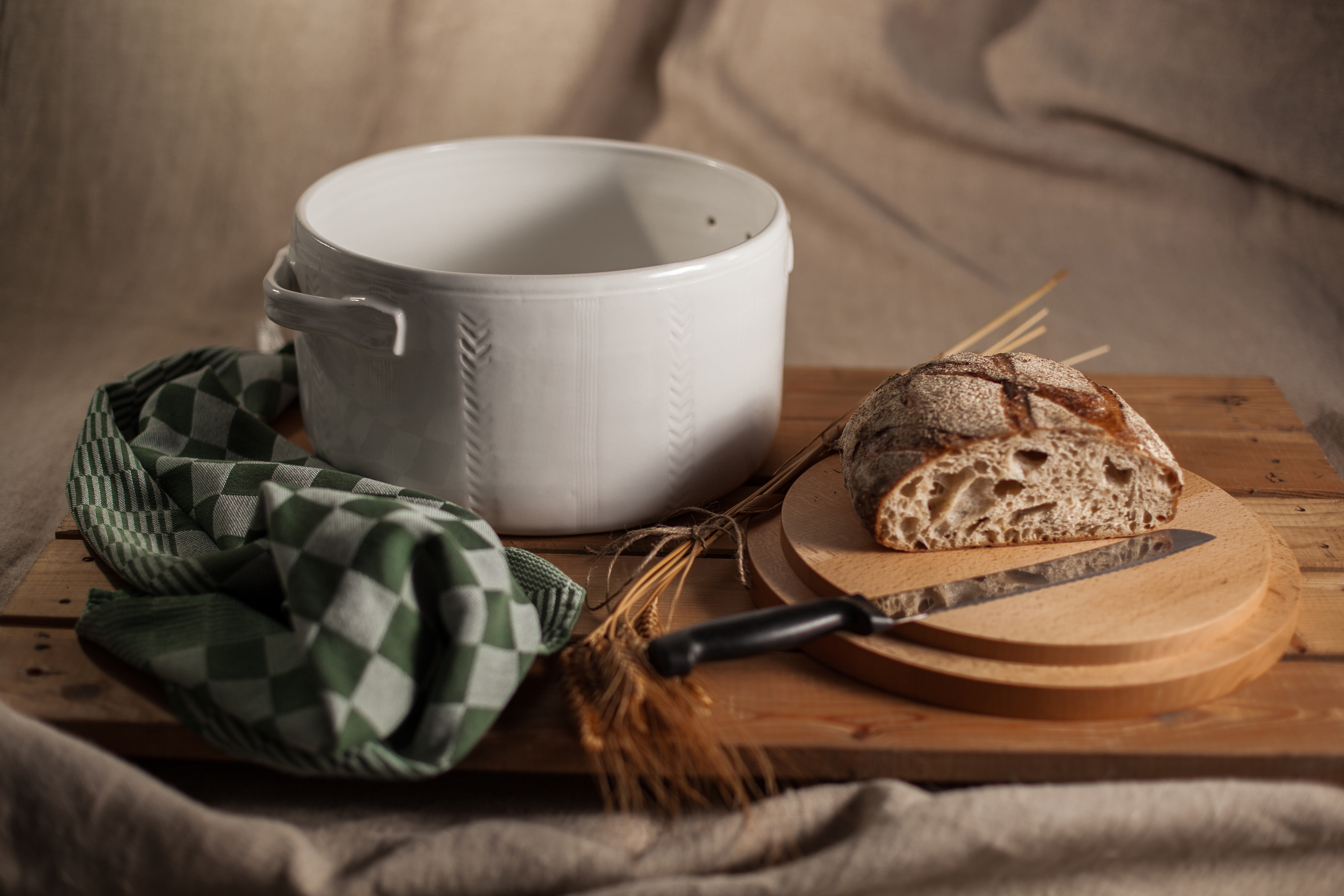 Bread pot,wheel thrown, wooden lid to be used as bread board. Stoneware, surface decoration, white glaze.